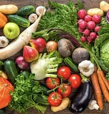 A colourful spread of fresh vegetables and fruit, including beetroot, fennel, radish and squash.
